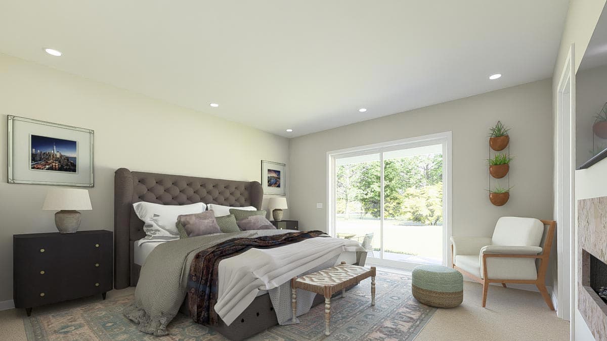 Primary bedroom with tufted headboard, large sliding glass door, and sitting area with armchair.