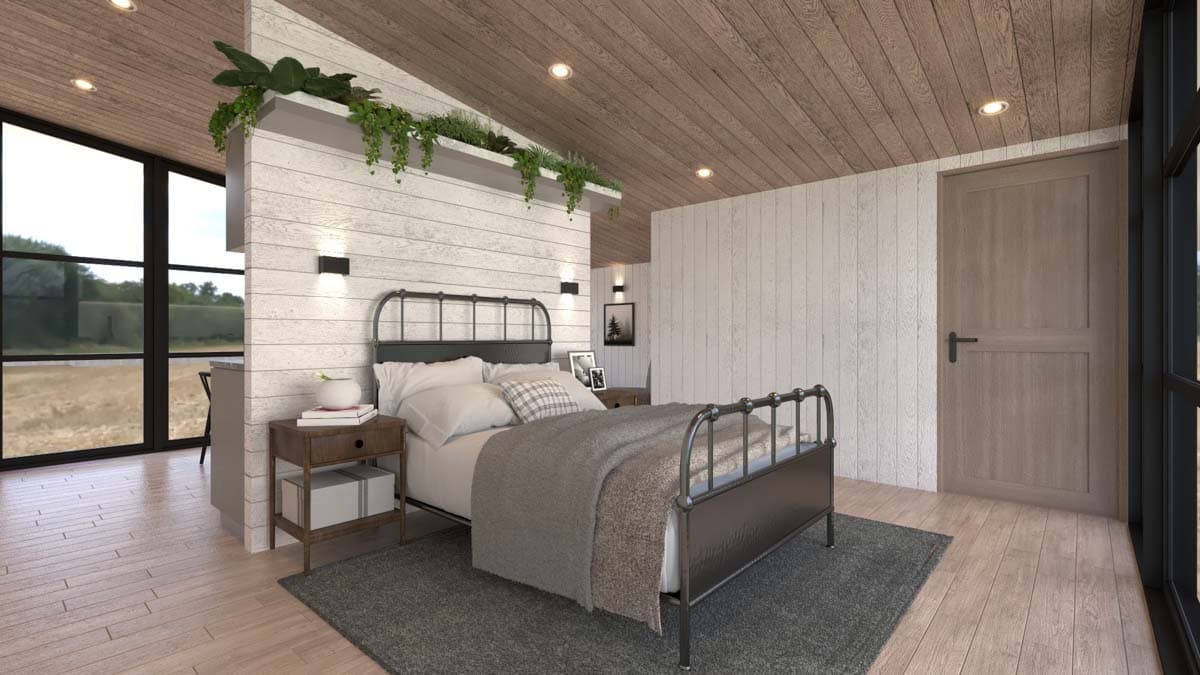 Bedroom interior with wood plank ceiling, shiplap walls, metal bed frame, nightstand, and large windows.