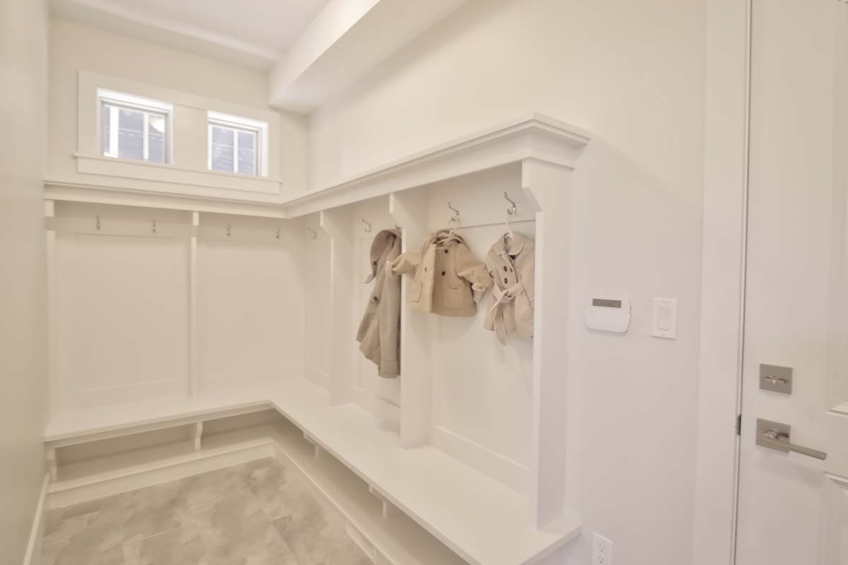 Mudroom with built-in cubbies, bench seating, and two transom windows above.