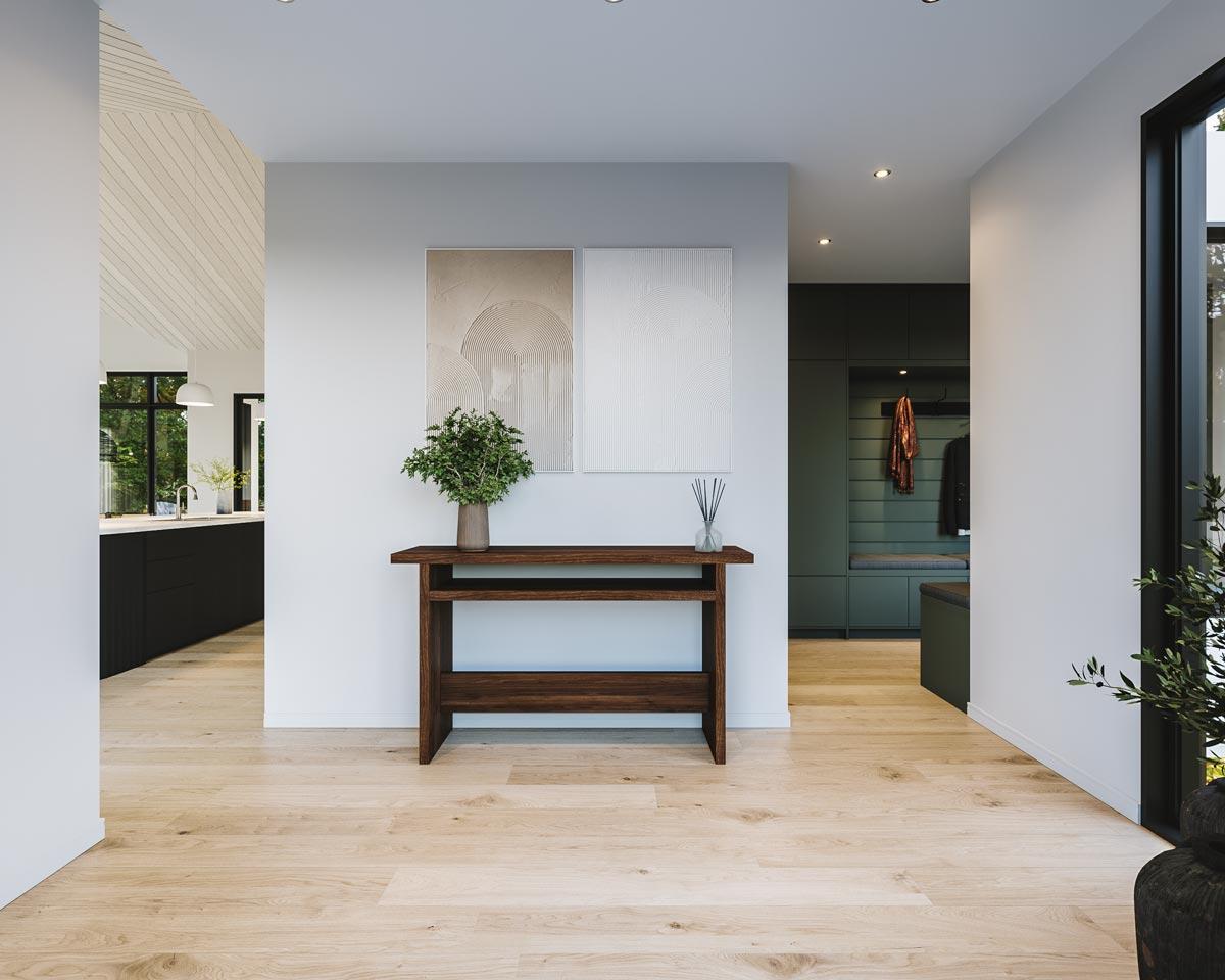 An entryway with hardwood floors leading to a kitchen and a hallway with a coat rack. A wooden console table holds a plant and decor.