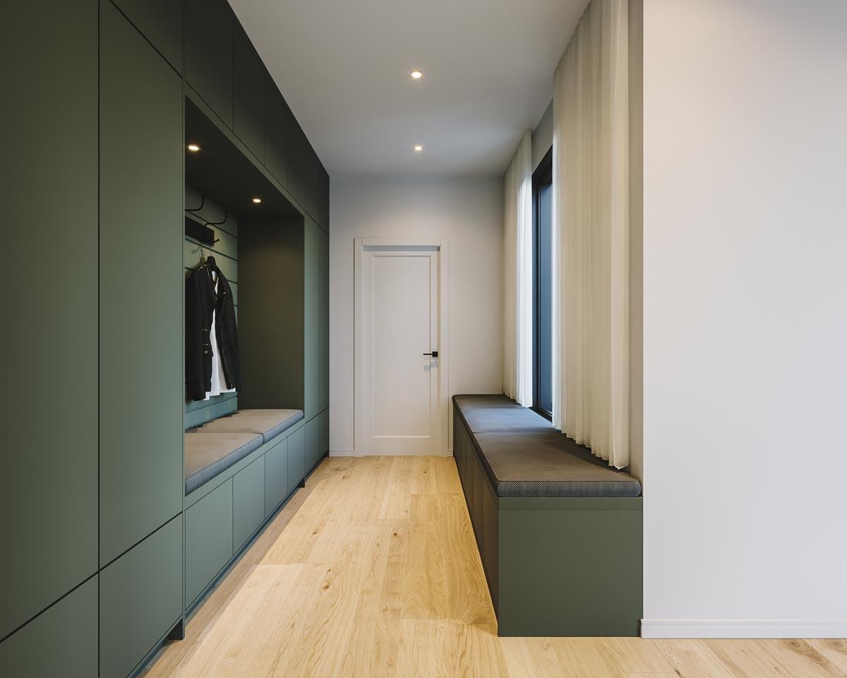 Modern hallway with green storage cabinets, a bench seat near a window, and a light wooden floor, with a coat rack and a white door.