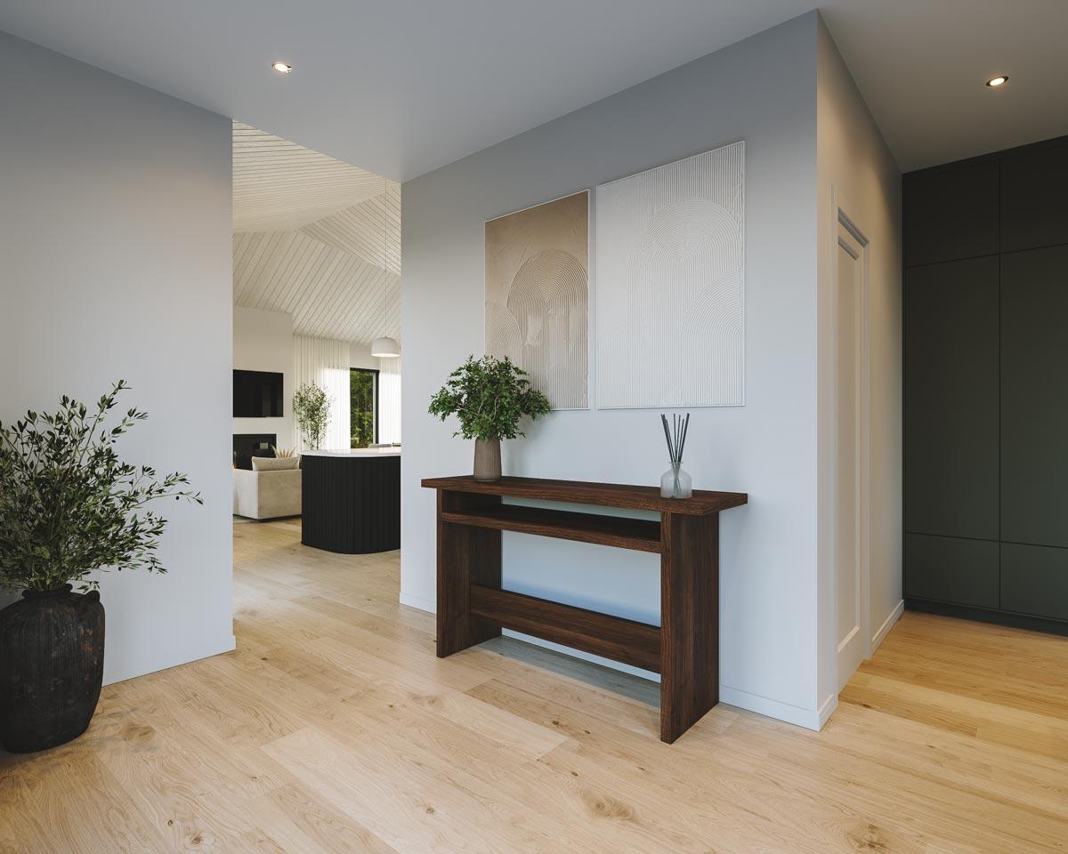 Modern interior entryway with hardwood floors, a dark wood console table, art, and a glimpse of an open kitchen in the background.