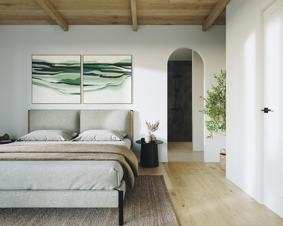 A modern bedroom with a bed, artwork, and a doorway leading to a bathroom. The room has light wood flooring and a neutral color palette.