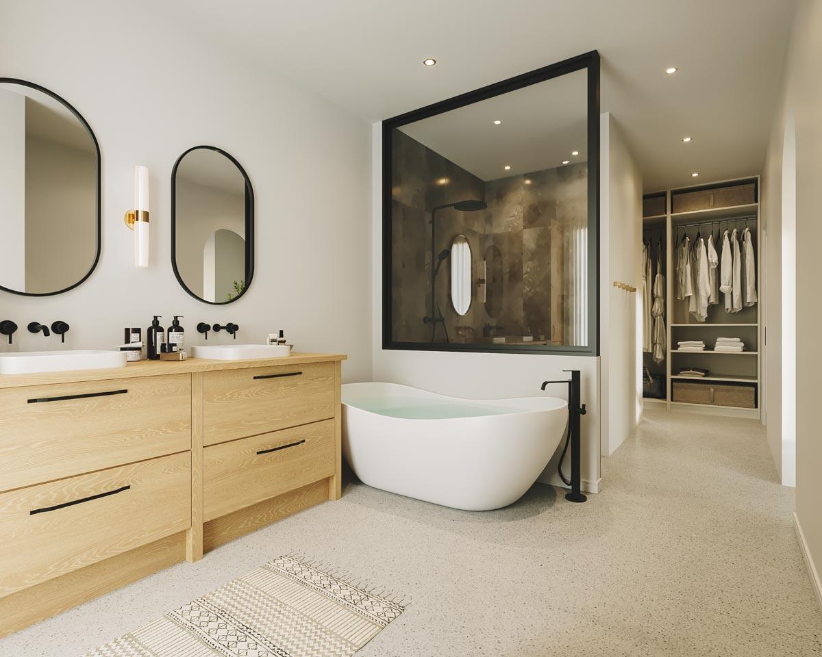 Modern bathroom with a freestanding tub and walk-in closet. Light wood vanity with two sinks and oval mirrors. Shower behind glass.