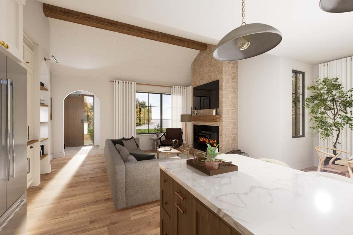 Interior rendering shows a great room with vaulted ceiling, stone fireplace, sofa, and kitchen island.