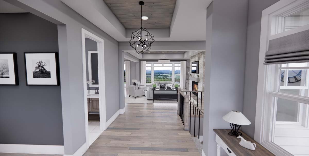 Hallway view toward living room with fireplace and large windows. Wood plank ceiling with geometric light fixture.
