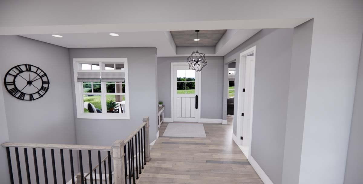 Interior view of a house entryway featuring a Dutch door, modern geometric chandelier, staircase with black railings, and a large wall clock.