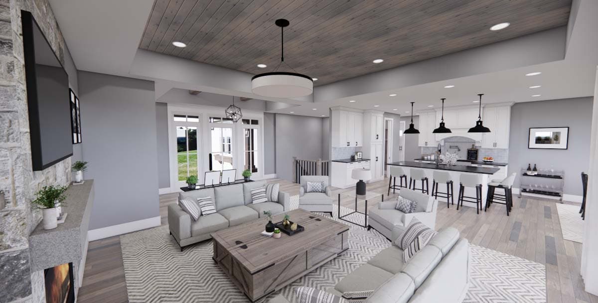 Open concept living room and kitchen with stone fireplace, wood plank ceiling, white cabinetry, and large island with bar seating.