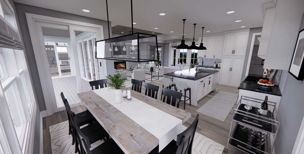 Open concept dining, kitchen, and living area with fireplace and island.