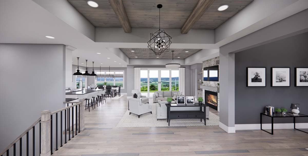 Open concept living area with kitchen island, fireplace, and large windows. Wood beamed ceiling with modern chandelier.