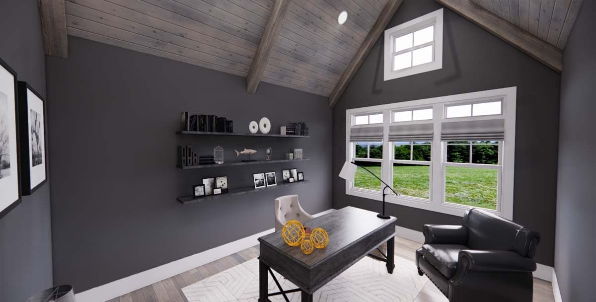 Home office with dark gray walls, exposed wood beams, a desk, chair, and large windows overlooking a yard.
