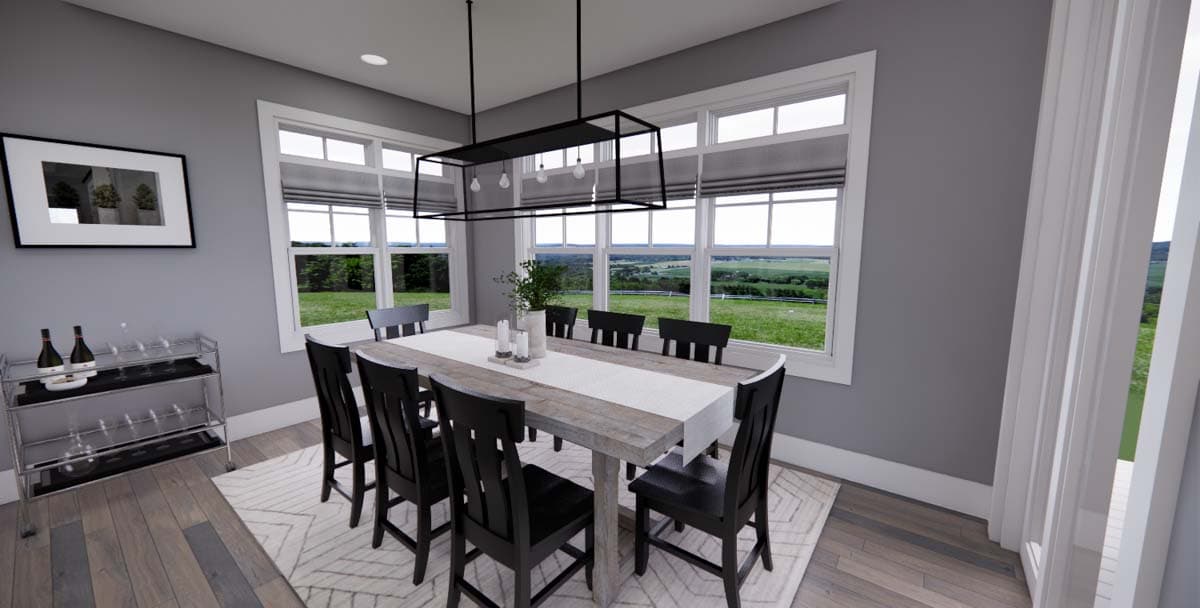 Dining room with wood table, chairs, modern chandelier, and large windows overlooking landscape.