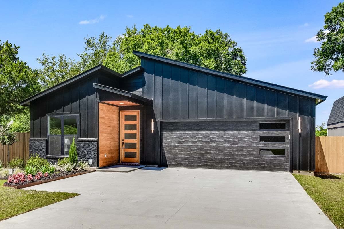 Modern house plan exterior with a standing seam metal roof, wood entryway, and horizontal garage door with horizontal windows.