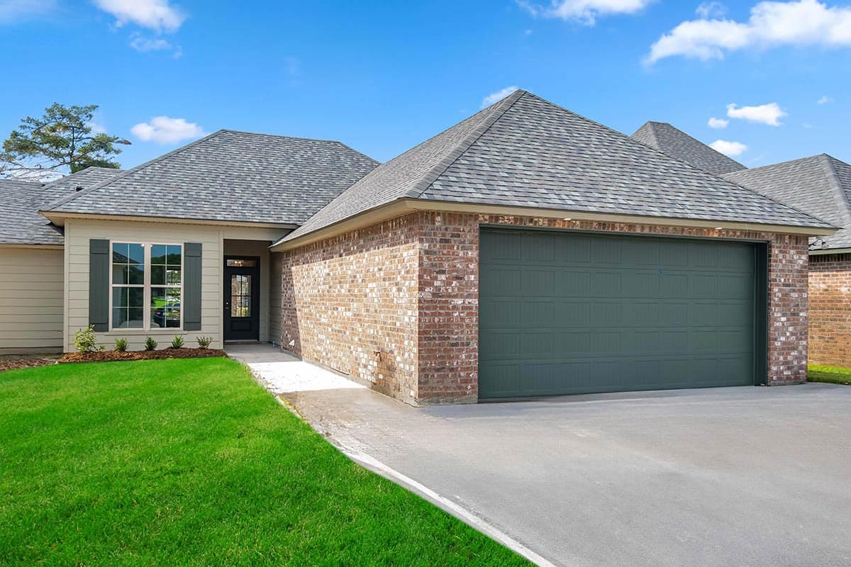 House plan exterior. Ranch style with brick facade and front-facing garage. Features include gabled roof, shutters, and covered entry.