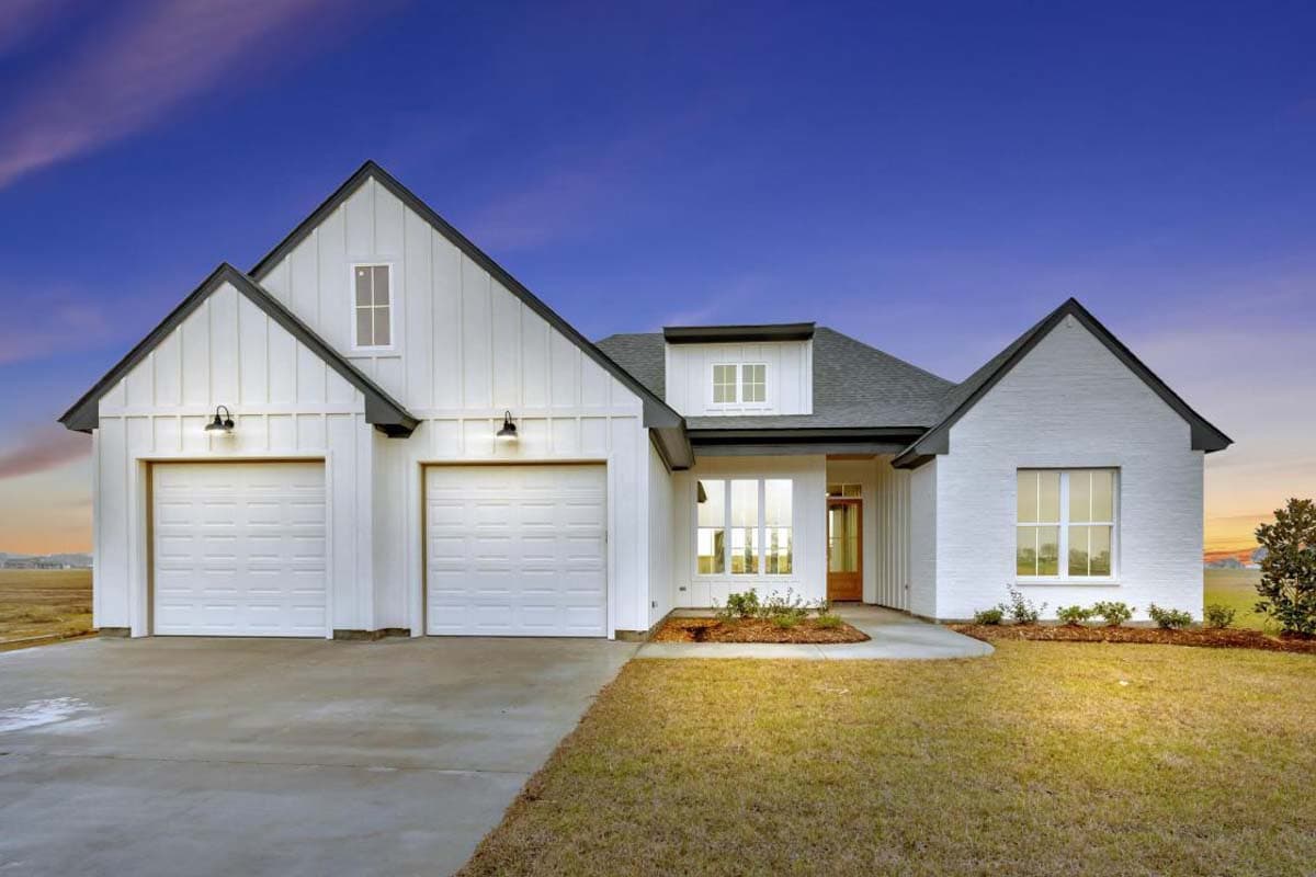 Modern Farmhouse house plan exterior with a two-car garage, board and batten siding, white brick, and multiple gables.
