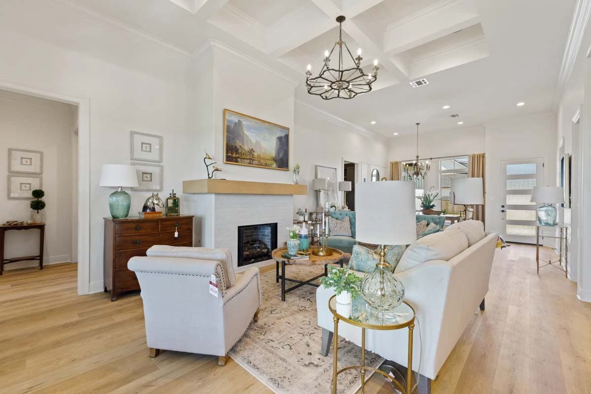 Open living area with coffered ceiling, fireplace, and seating area.