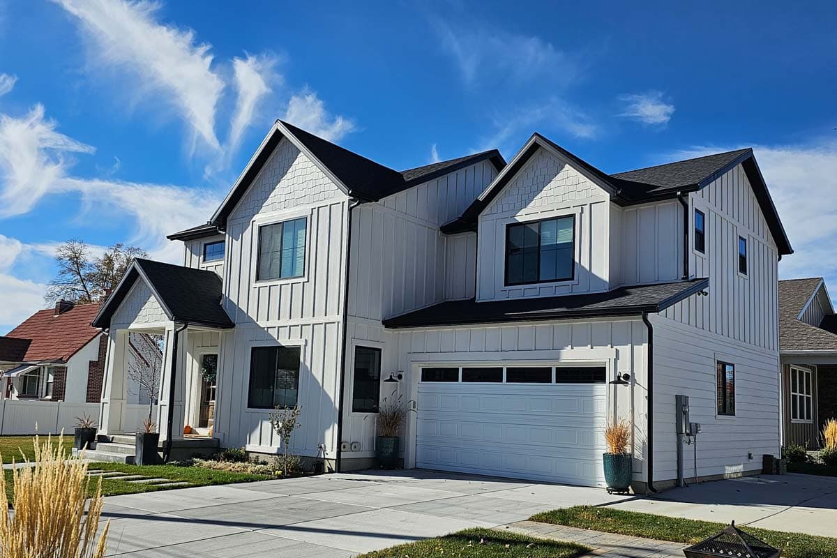 Modern Farmhouse two-story house plan exterior with board and batten siding, prominent gables, and a covered front porch.