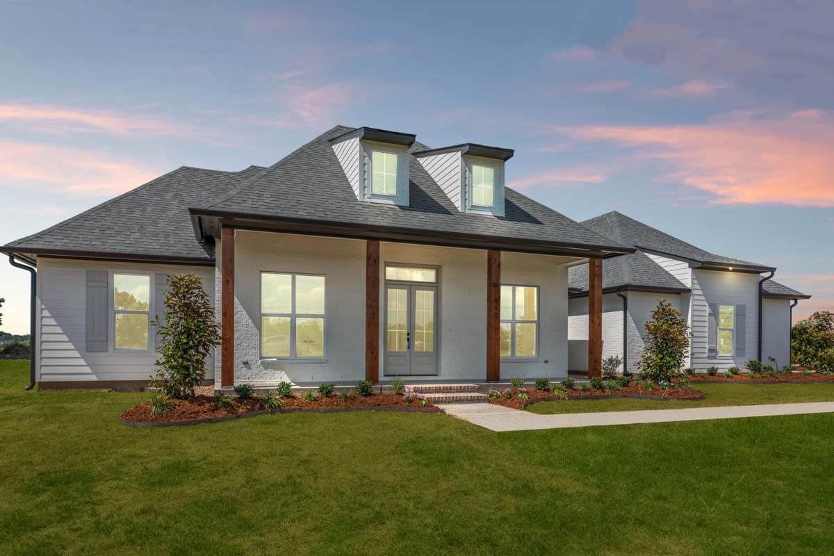 House plan exterior: A one-story modern home with a prominent covered porch, dormers, and wide windows.
