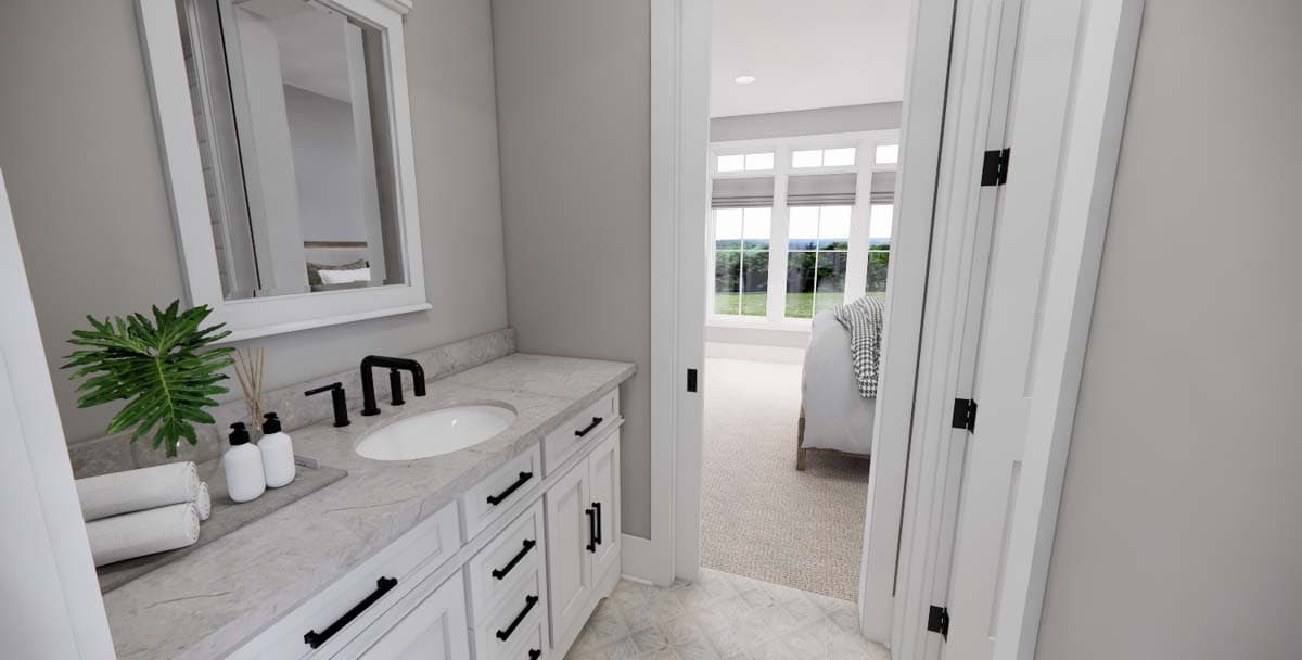 Bathroom with vanity, sink, and mirror, opening to bedroom with large windows.