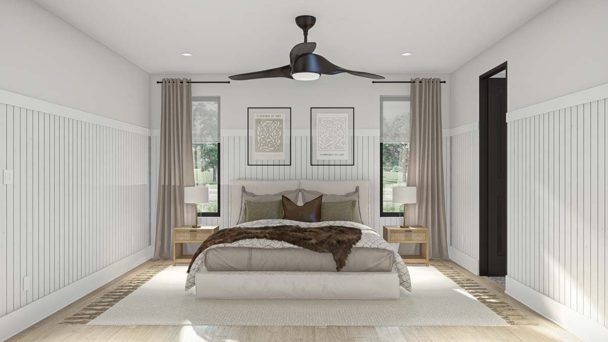 Primary bedroom with paneled walls, two windows with neutral curtains, and a modern ceiling fan.