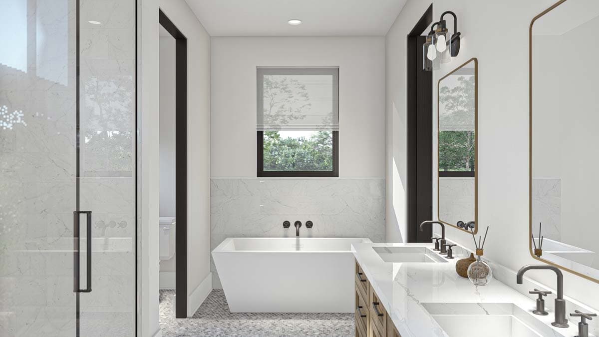 Modern bathroom with freestanding tub, double vanity with marble countertops, and glass-enclosed shower with marble tile.