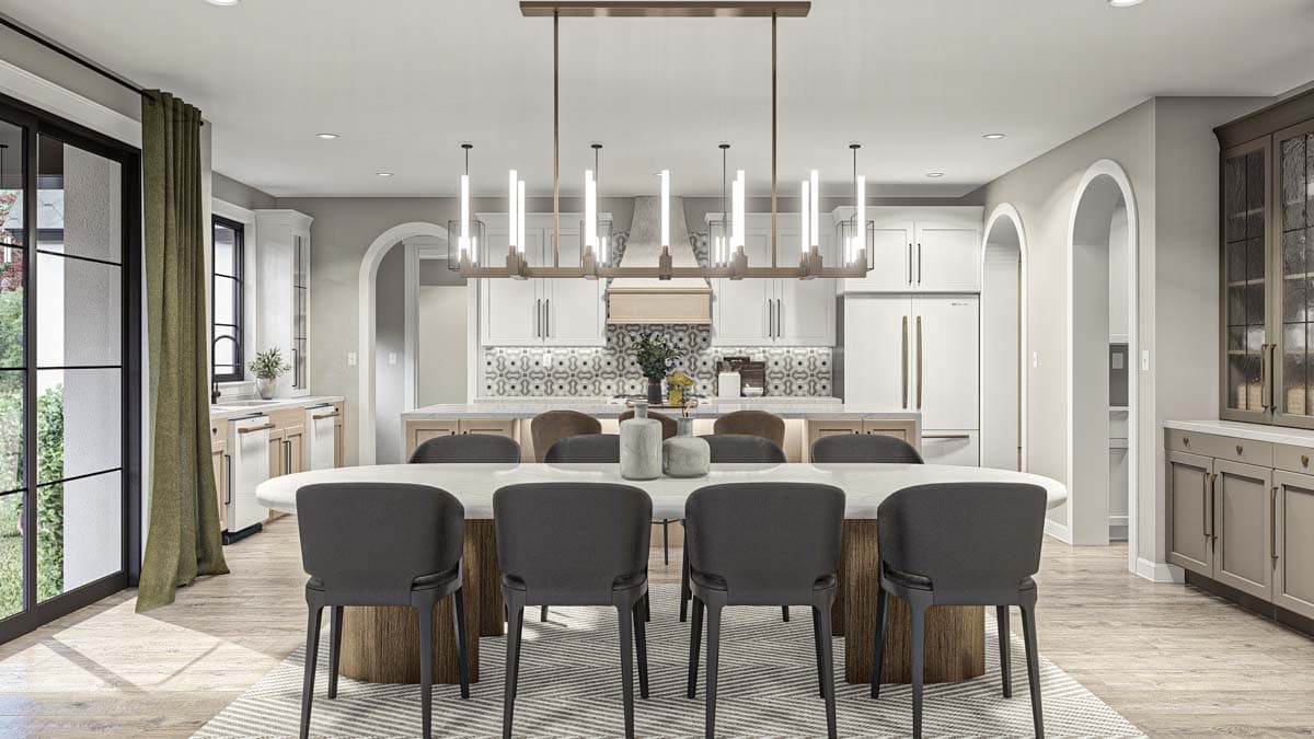Open-concept dining area and kitchen with large island, modern chandelier, and white cabinetry.