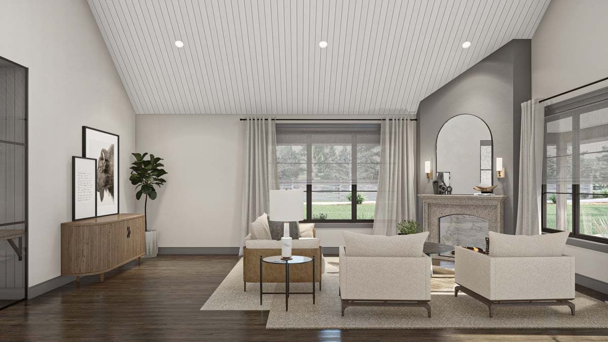Living room with vaulted ceiling, fireplace, arched mirror, and two sofas.
