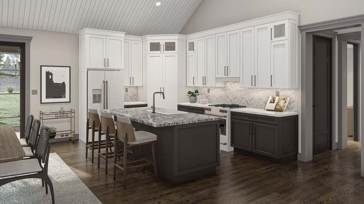 Kitchen interior with white cabinets, dark island with stone countertop, stainless steel appliances, and vaulted ceiling.