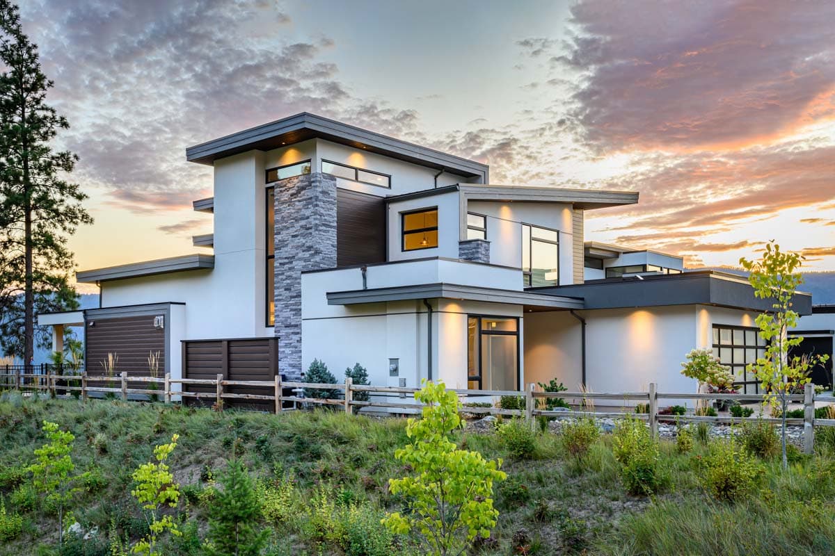 Modern house plan exterior with stacked stone accents, multiple gables, and a two-car garage.
