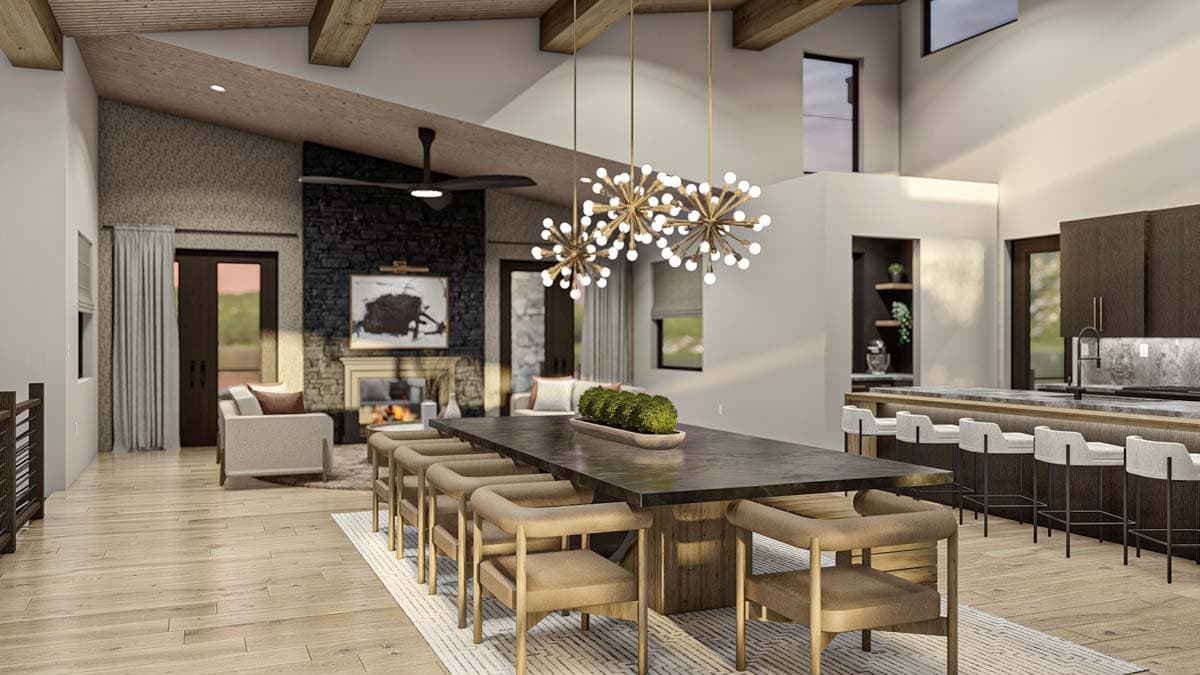 Open concept living area with vaulted wood beam ceiling, stone fireplace, dining area, and kitchen island with seating.