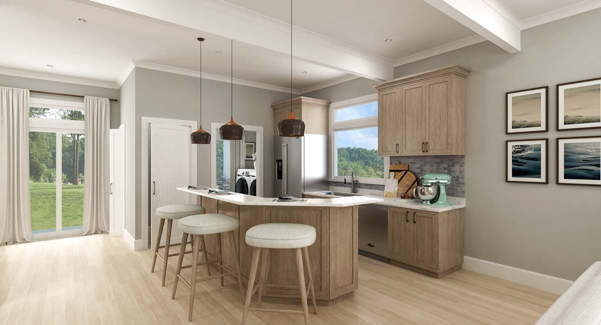 Kitchen with angled island, pendant lights, wood cabinetry, stainless steel appliances, and view of laundry area.