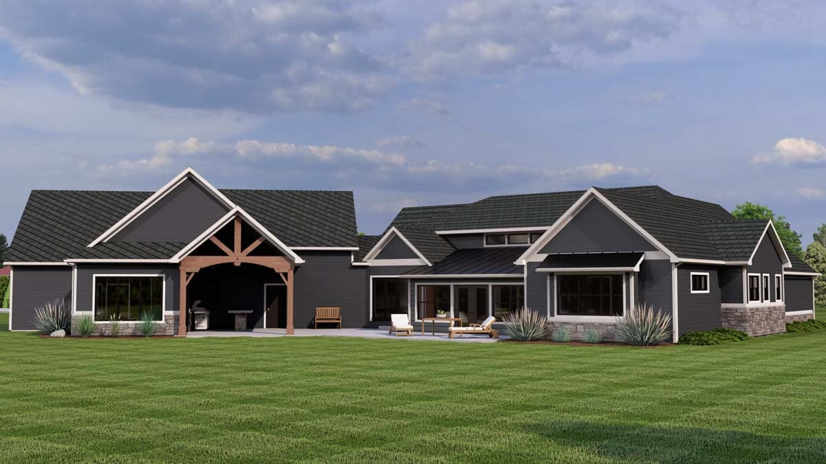 House plan exterior: Modern Farmhouse style with a covered outdoor kitchen, stone accents, and multiple gables.
