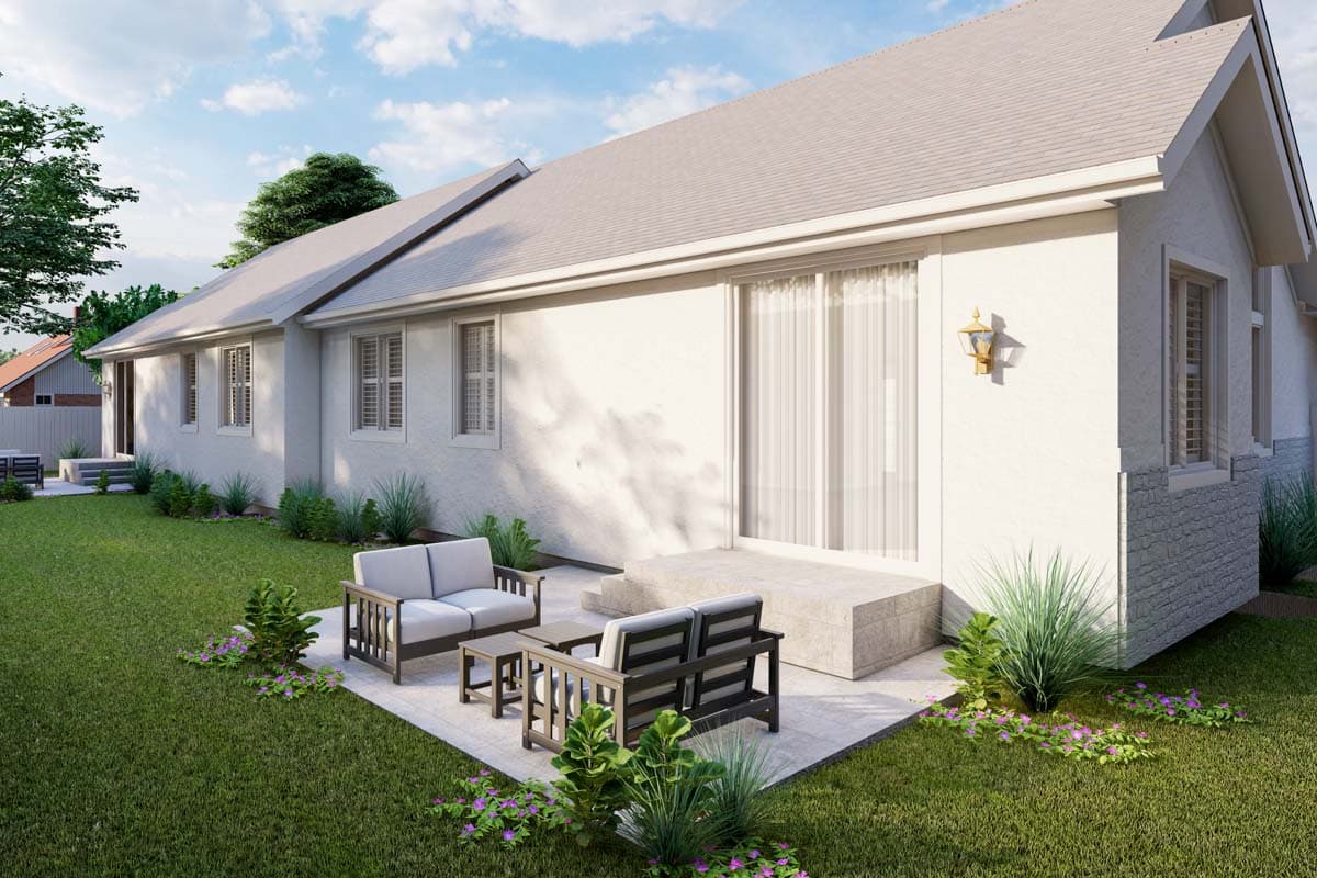 House plan exterior featuring a white stucco finish, gable roof, multiple windows with shutters, and a patio area with seating.