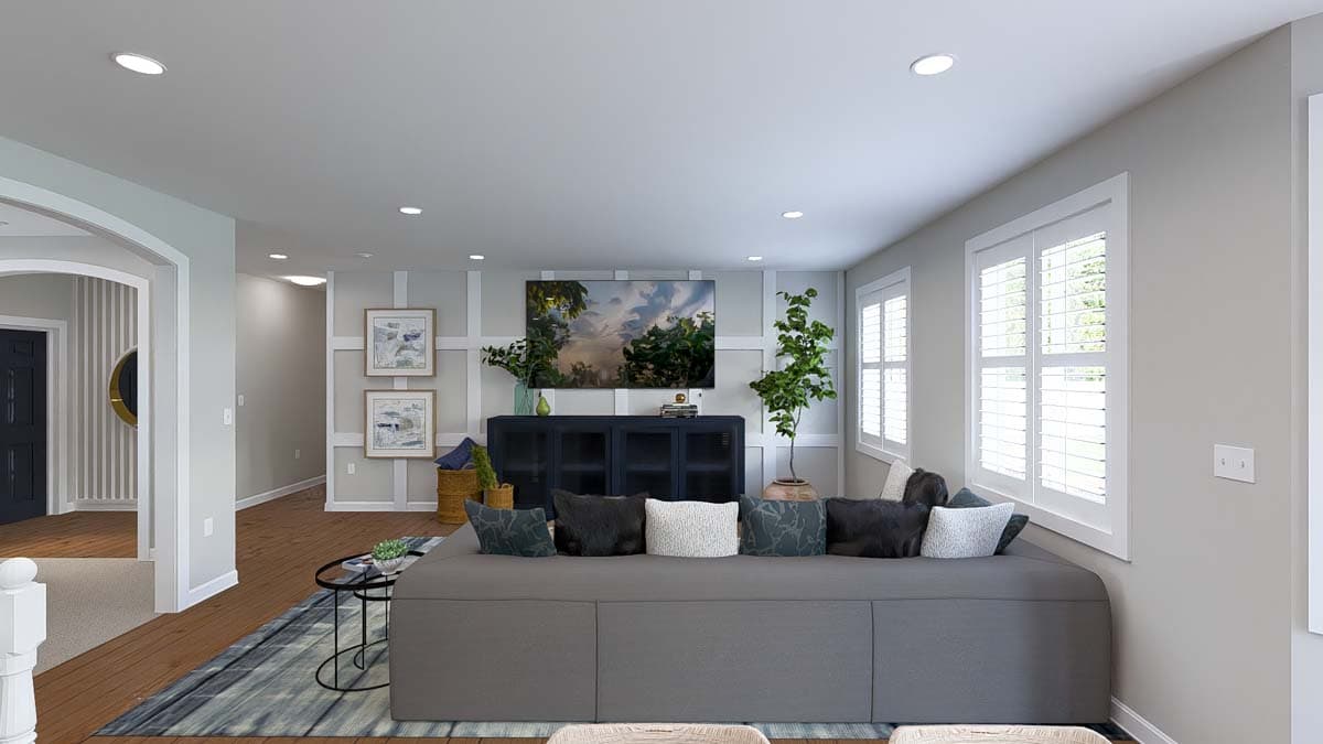 Open concept living area with a large sectional sofa, wall-mounted television, and entryway view.