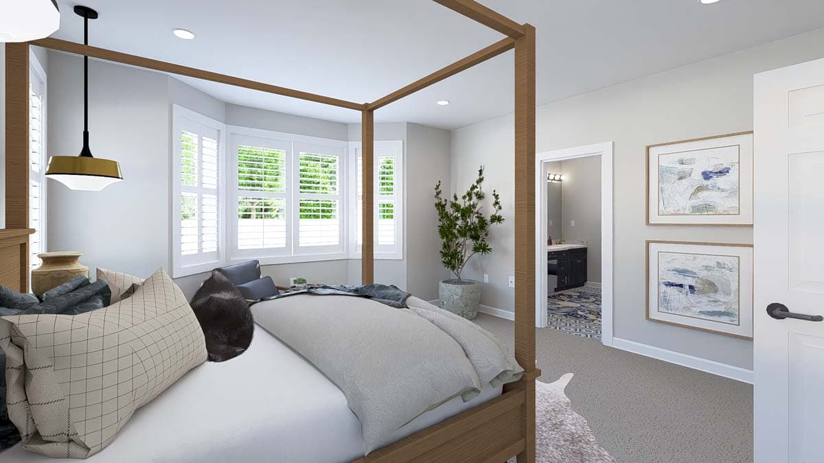 Bedroom with canopy bed, bay window with shutters, and adjoining bathroom entry.