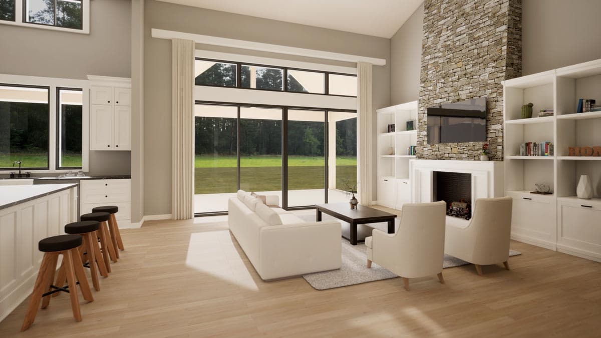 Open-concept living area with large windows, stone fireplace, built-in shelving, and kitchen island.