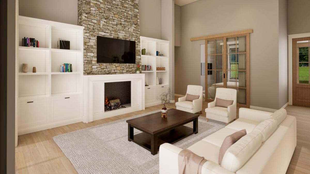 Living room with stone fireplace, built-in shelving, seating, and sliding glass doors.