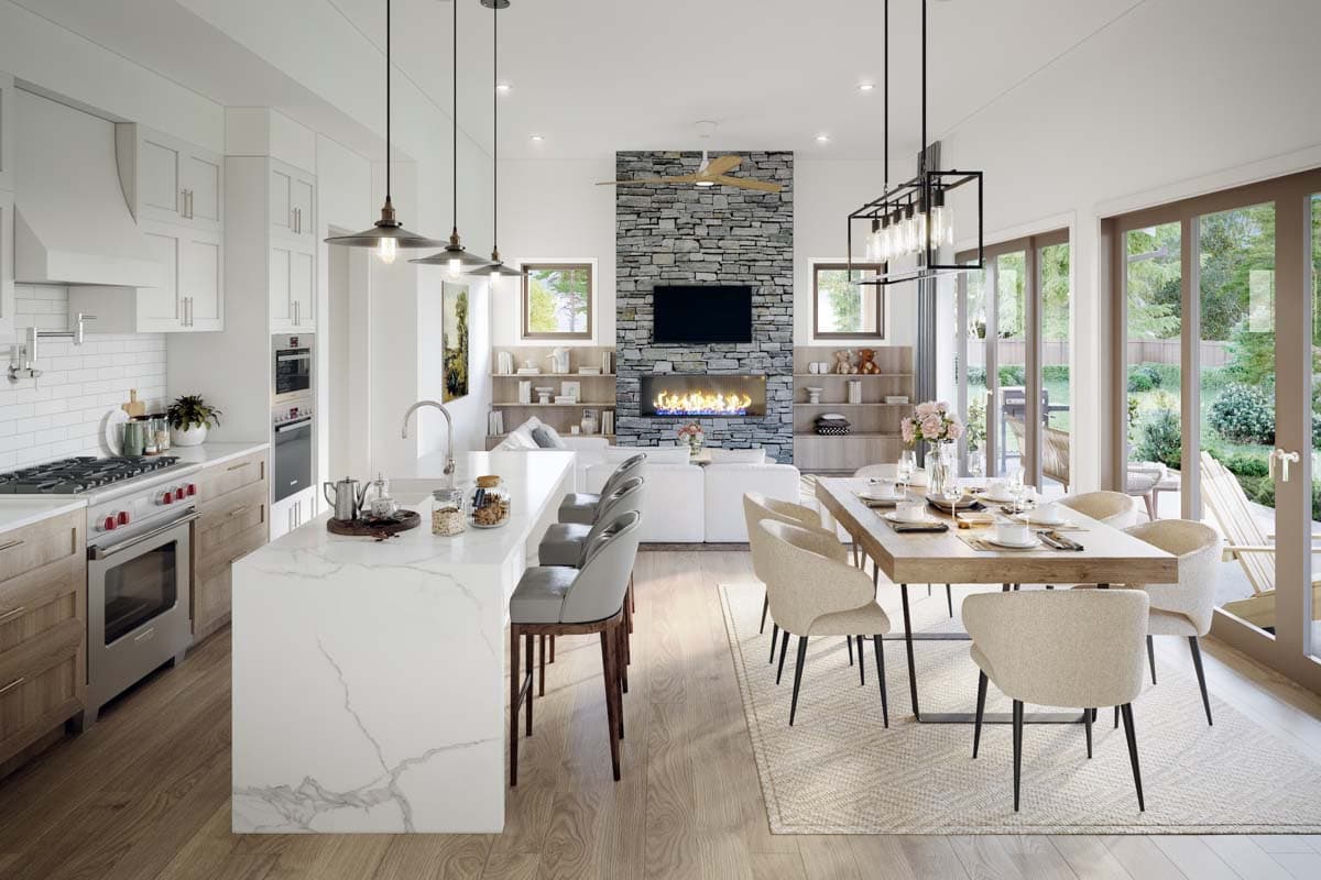 Open concept kitchen, dining, and living area with stone fireplace, large island, and sliding glass doors.
