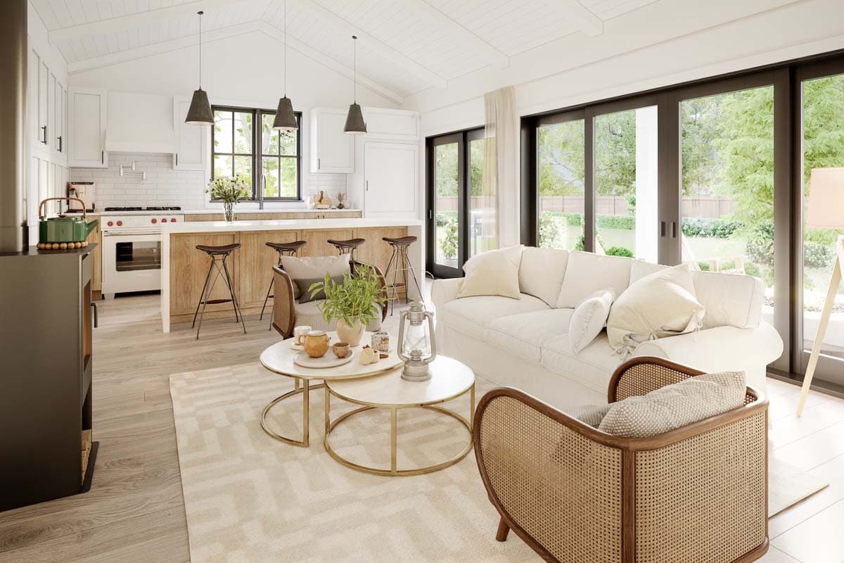 Open-concept living space with vaulted ceilings, kitchen island with bar stools, and large sliding glass doors.