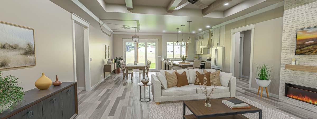 Open concept living area with sectional sofa, fireplace, dining table, and kitchen with island and ample cabinetry.