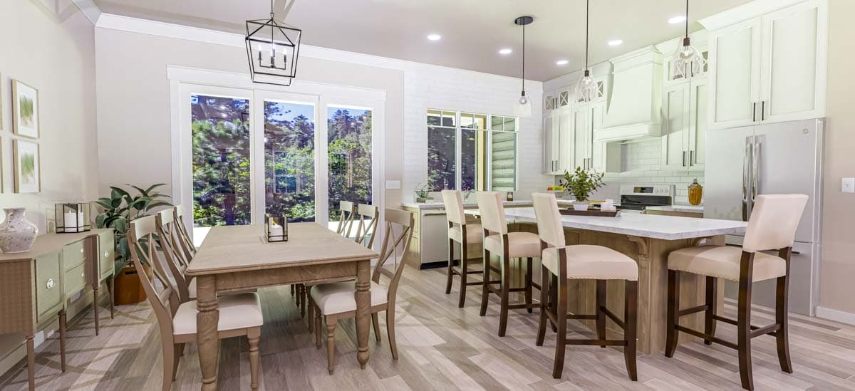 Open concept dining area and kitchen with island seating, white cabinets, and large windows.