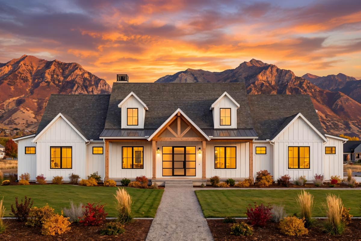 Modern Farmhouse house plan exterior with white board and batten siding, prominent gables, dormers, and a timber-frame covered entry.
