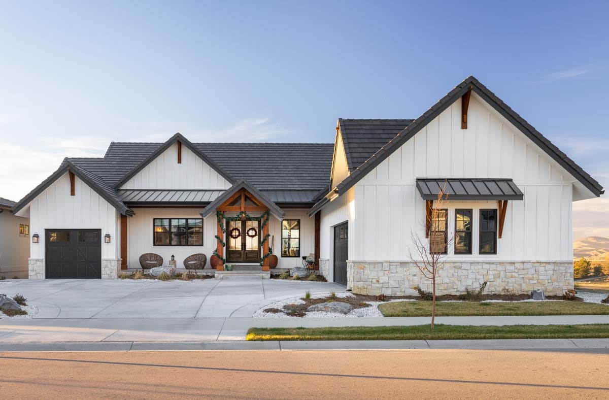 Modern Farmhouse exterior with board and batten siding, stone accents, gables, and a covered front entry.