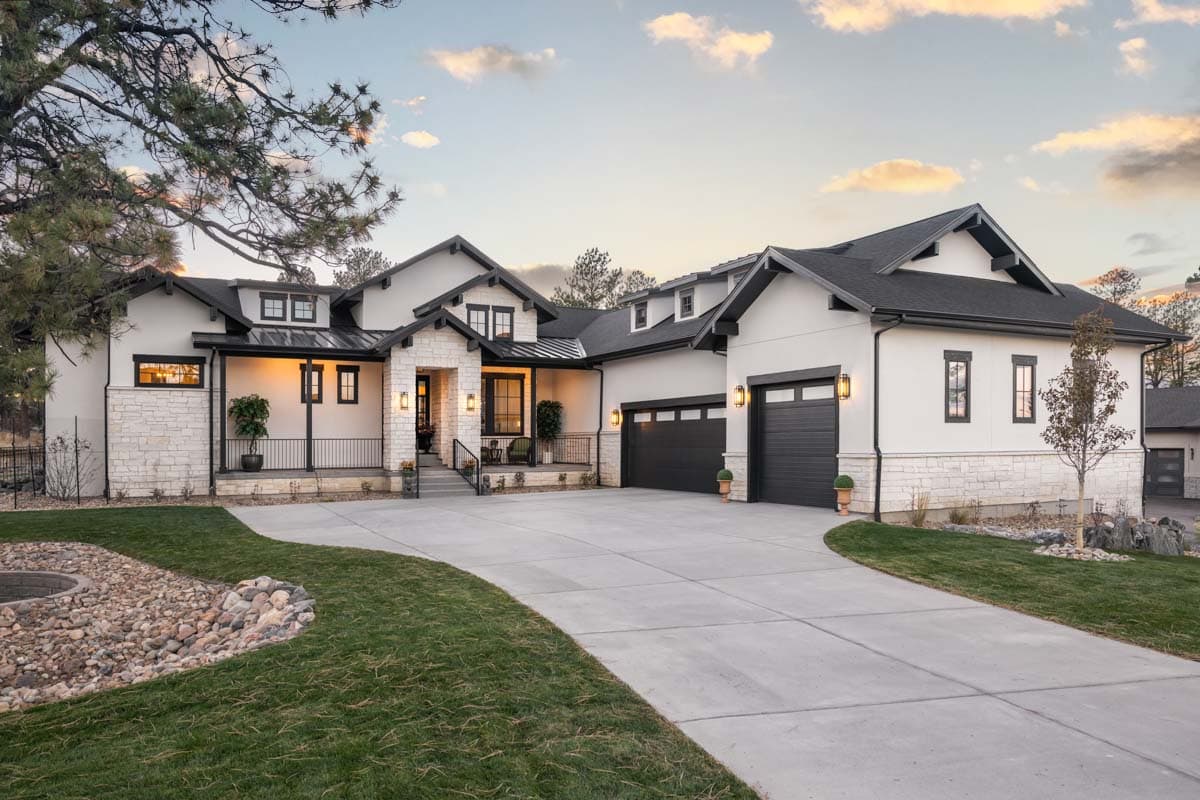House plan exterior with Modern Farmhouse style, two stories, front porch, gables, and attached garage. Stone and stucco exterior with dark trim.