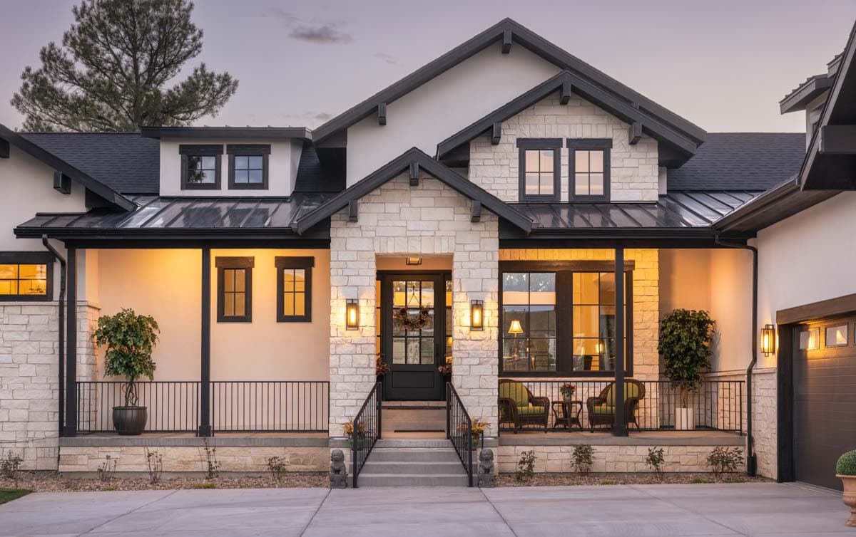 Modern Farmhouse house plan exterior with stone facade, metal roof, prominent gables, covered porch, and attached garage.