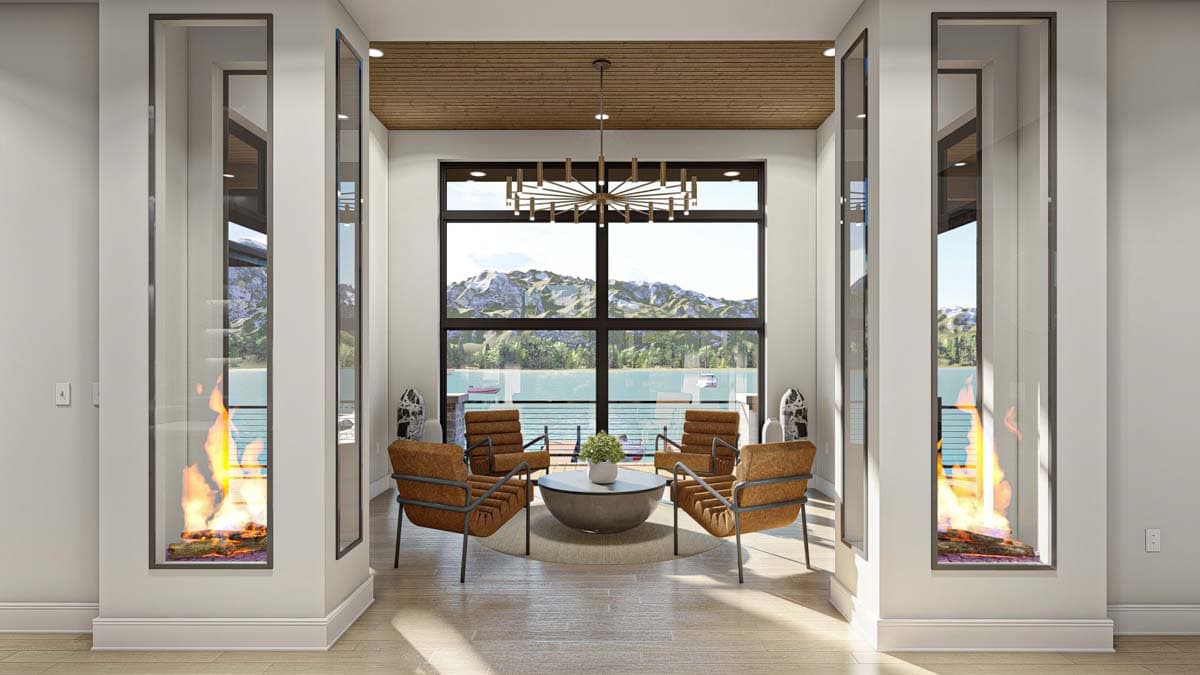 Modern living space with lake view, large window, four chairs around a table, and fireplaces built into the walls on either side.