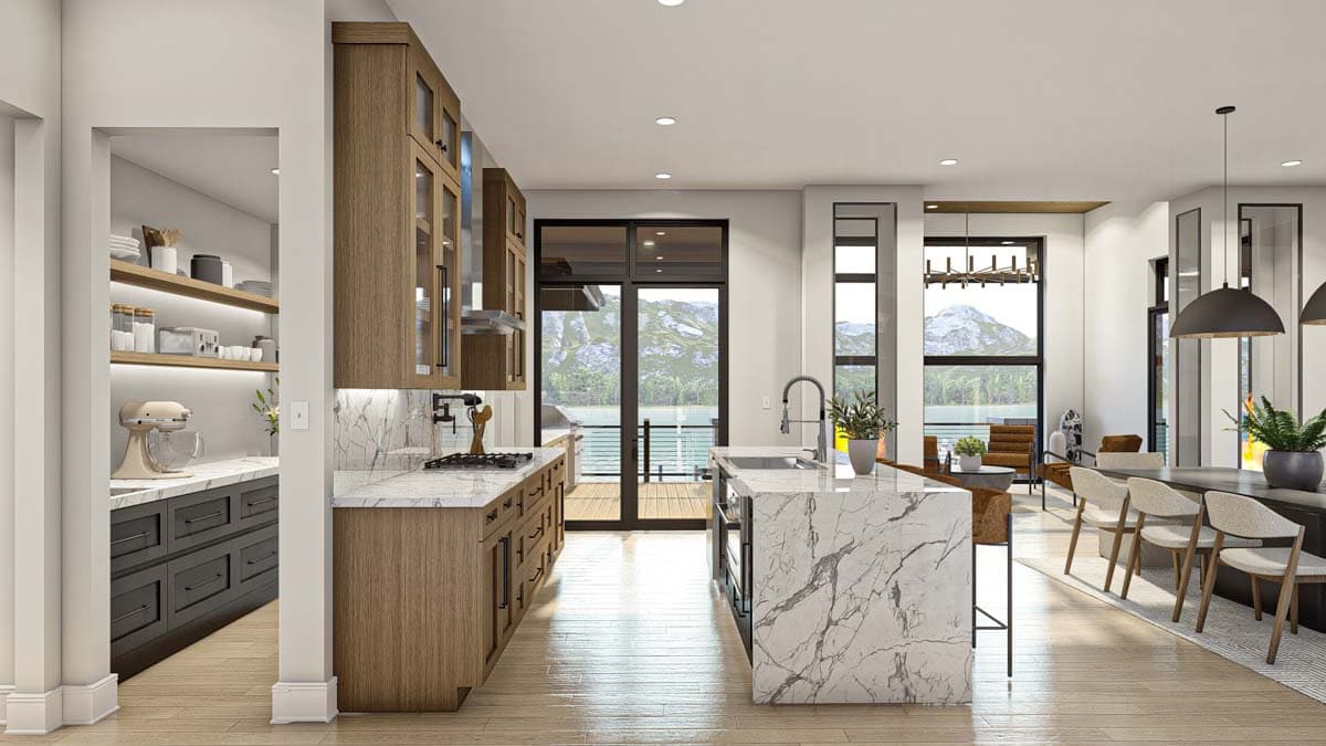 Modern open-plan kitchen with wooden cabinets, marble countertops, an island, and large windows with a scenic mountain view.