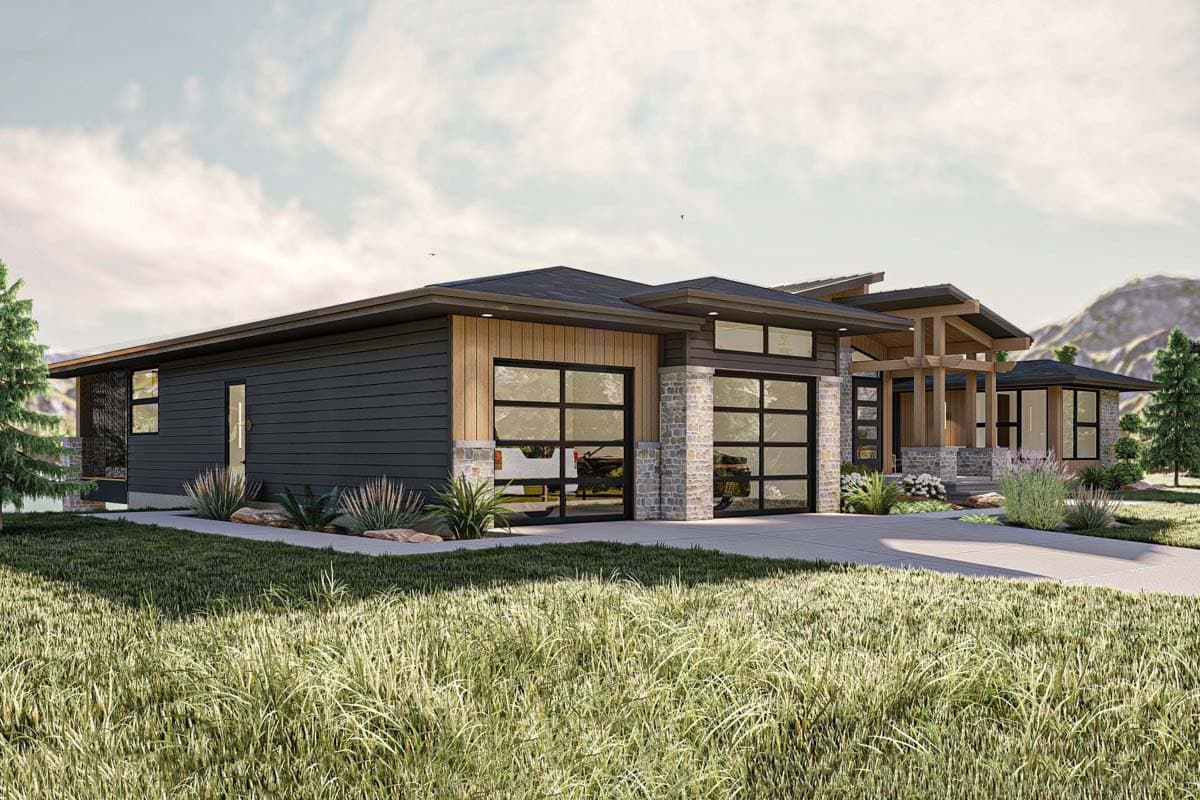 A modern, multi-section house with dark siding, stone accents, and large glass garage doors. The facade features wood trim and a sloped roof.
