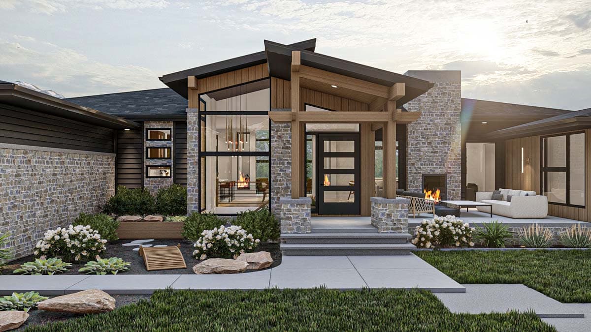 Modern home exterior with stone accents, large windows, and an outdoor fireplace. A landscaped yard leads to the front entrance with a glass door.