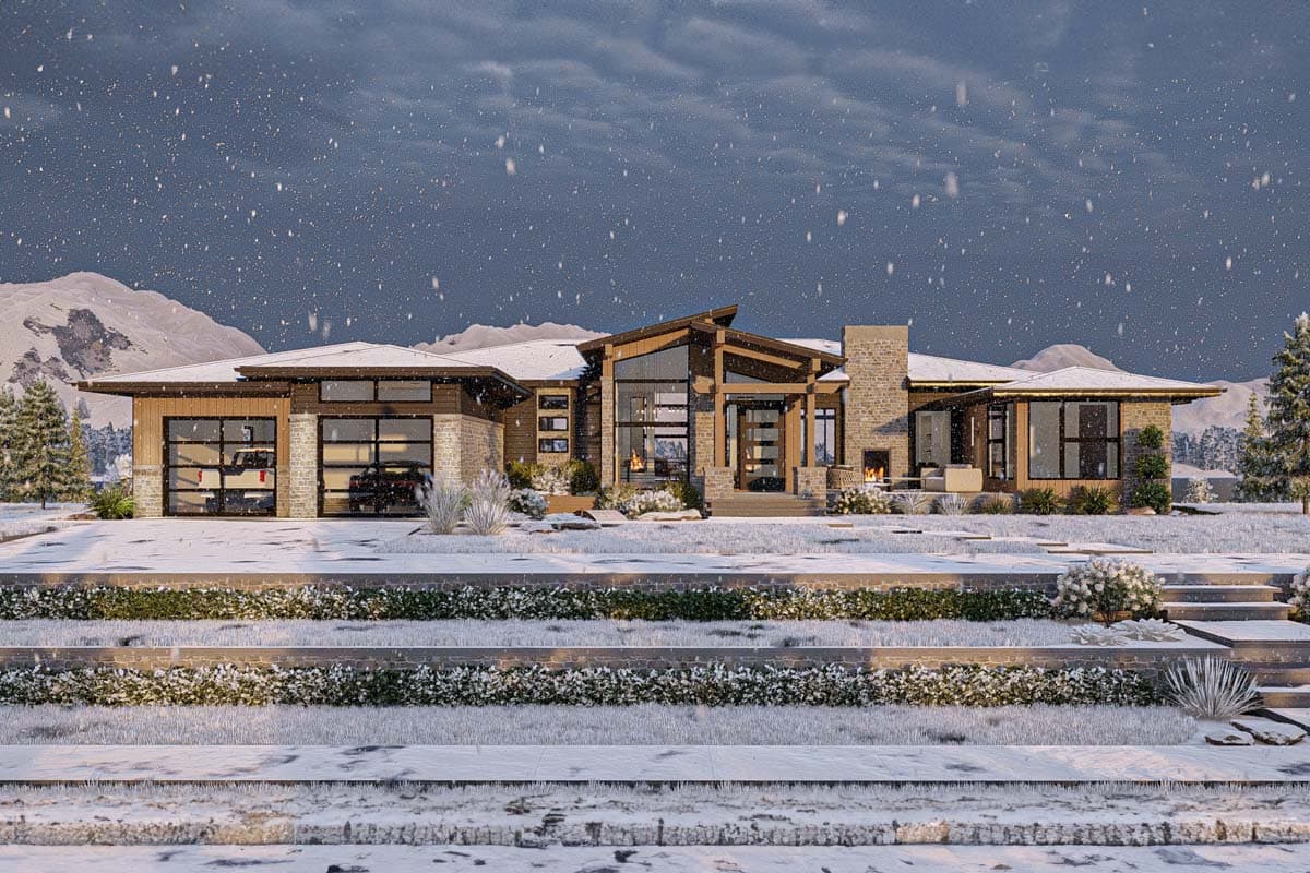 A modern, multi-sectioned house sits in a snowy landscape. The front entrance features a glass door, and a cozy fireplace can be seen.